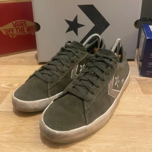 Olivgröna sneakers från Converse - Snygga olivgröna ”Converse Cons” vit sula och stjärndetaljer på sidan. Skorna har snörning och är tillverkade i mocka för en stilren look.                   -Är en herrsko men som passar både tjejer och killar.                                                                                 - Det ingår även vita skosnören (om man vill) samt låda