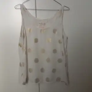 White top with golden dots. Size S. Shipping is not included.