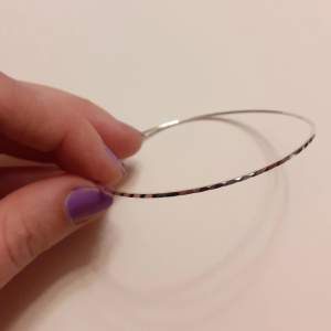 Silverarmband i nyskick. Armbandet är format som en ring och diametern är 6,5 cm 