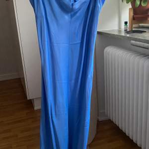 Säljer denna superfina blå klänning i satinimitation. Endast använd en gång.
