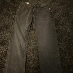 Ett par mörk gråa hm jeans