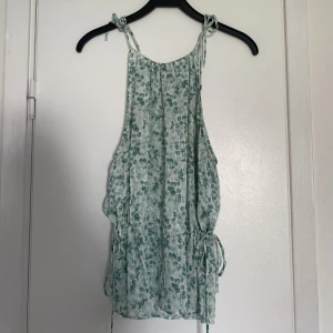 Topp från hm - Säljer denna otroligt snygga sommar toppen från hm som är slutsåld. Storlek M men passar S då man kan dra åt från sidorna och runt axlarna. 