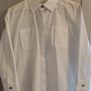 Busnel vit bomullsskjorta vit i lite längre modell endast provad.