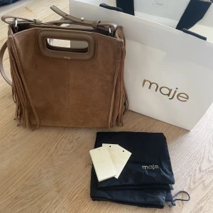 Maje väska - Säljer nu min ursnygga väska från Maje! Köpt i höstas för 2500kr och säljer nu för 1900kr. Allt på bilden medföljer (Den vita påsen endast om man möts upp av fraktskäl). Den är i fint skick och använd ett fåtal gånger💕