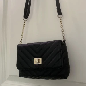 Svart handväska  - Säljer denna söta svarta handväska från Primark! Köptes från en annan på plick men säljer då jag inte blev helt nöjd 💗 Liten repa på undersidan (bild 2) men inget som märks.