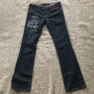 Ett par mörkblå ed Hardy jeans i strl 27 med tryck på högra låret. Köpta på secon hand, bra i skick men änvända💞startpris: 850kr+frakt🤍 skriv privat för mer information🙏
