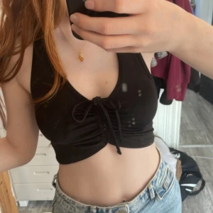 Halterneck linne svart - Linne med knyte fram och öppen rygg, knappt använd, stretchigt material