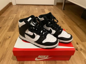 W Nike Dunk High - Nike Dunk high i svart och vit. Använd 2 gånger, är i väldigt bra skick. Säljer pga att de kommer inte till användning längre. Fråga gärna om fler bilder.✨