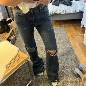 Bootcut jeans med slitningar. Alldeles för långa för mig och har inte orkat göra nått åt det, så väldigt sparsamt använda. De få gånger de använts har jag dock trampat lite på de. Syns knappt men bild kan självklart fås på det. Sista bilden visar färgen