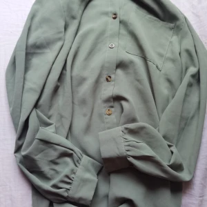 Solid knapp frambältad skjorta - Skön och går att staila på flera sätt. Storlek: S Leverans har ej räknats med i priset. 