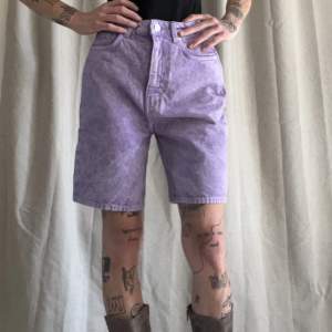 Helt oanvända shorts från Weekday i lila stentvätt. Oversized modell ”Dandy”. Mäter 34cm rakt över midjan. 