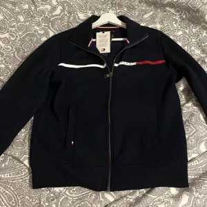 Tommy hilfiger zip up - Bra skick, aldrig använd. Ny pris 1200kr.