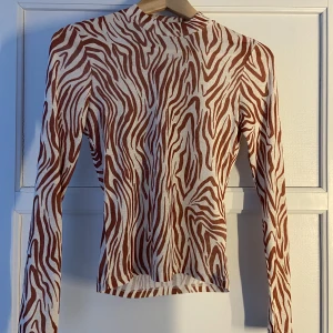 Mesh topp  - Fin meshtopp med zebra mönster i brunt! Köpte för ca 1 år sedan , använt endast en gång! Bra skick!   Priset är förhandlingsbart!!