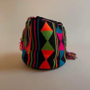 This vintage Mochila bucket bag is made in Colombia with colorful threads made of Cotton and Aloe.   The braided shoulder strap can be easily adjusted by tying a knot to shorten. Drawstring Closure with Fringed Tassels