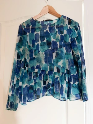 Söt blus  - En söt lite genomskinlig blus i olika nyanser av blått. Sitter lite löst ej åtsittande