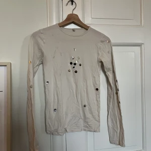 Party-topp - Fin party topp med silvriga detaljer. Små fläckar framtill som tyvärr inte går bort men ser ut som det är en del av tröjan! 