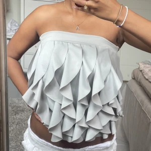 Grå volangtopp - Supersöt grå Tubtopp med volanger. Använd ca 2 ggr. Pris kan diskuteras