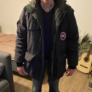 Canada goose jacka - Den var köpt cirka 2010 tjock jacka varm på vintern och täcker rumpan. Lite av ärmen är sönder som man ser på andra bilden men det tar inte bort någon funktion av jackan.