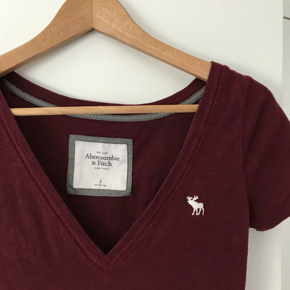 Lite längre vinröd T-shirt från Abercrombie & Fitch. T-shirts.