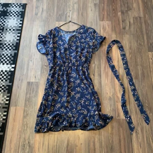 Blå blommig klänning strl 40 - Den är lite mindre i passform, skulle säga att den passar som en mindre M eller större S. En loop som bältet ska gå igen har gått sönder men bältet går fortfarande att använda. Jag kan mötas upp i Stockholm och tar emot både swish och kontanter. Vill bara bli av med allt! Pruta gärna! Kan säkert fixa bra paketpris! 