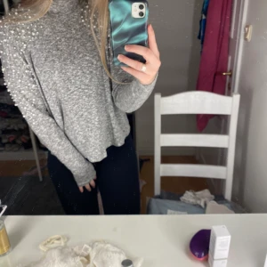 Tröja med pärlor på axlarna - Hej säljer min tröja med pärlor på axlarna från h&m st S. Väl använd där av att tyget fått små knoppor men syns ej. Annars har tröjan inga skador elle fläckar