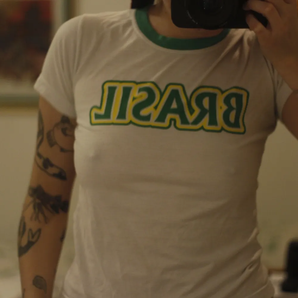 Vit t-shirt med grön krage och texten ”Brasil” på . Toppar.