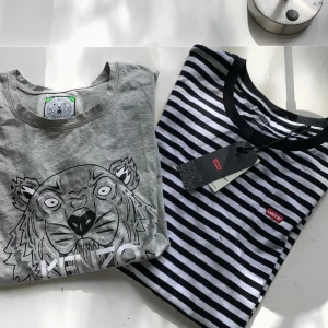Tshirts - Två stilrena t-shirts, ena helt oanvänd med lapp kvar å andra använd fåtal gånger men i gott skick! 100kr styck eller 150 för båda💕 levis str L å kenzo S