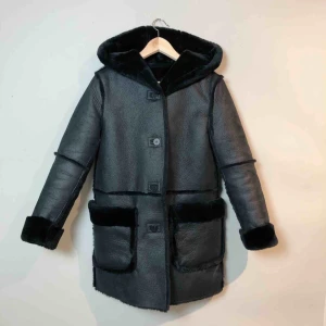  - Varm/tjock jacka som är helfodrad i pälsimitation. Kan användas även när man vänder ut-och-in på den. Stor mysig huva! Notera att en knapp behöver sys dit bättre och ena fickan har lossnat i övre kant.  Ca. 44cm över axlarna Ca. 78cm i längd 