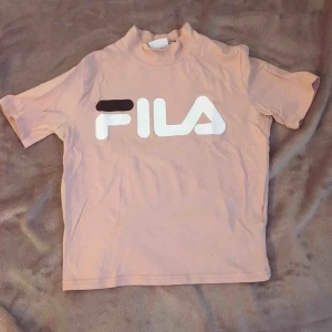  - Säljer en jättefin t-shirt från fila, med en liten polokrage. Den kan användas till både träning och vanliga kläder. (Den är lite skrynklig för den har legat nedvikt länge) 