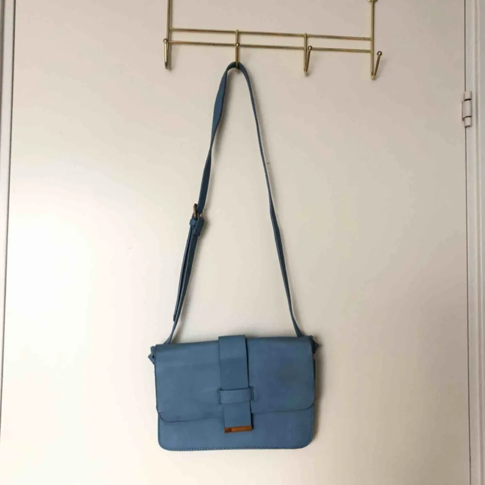 En jättefin blå axelremsväska!!💫💙 Köpt från Lindex och är perfekt nu till våren och sommaren! Köparen står för frakten!!. Väskor.