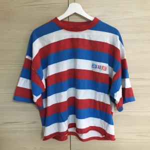 Randig t-shirt - Blå/vit/röd t-shirt köpt second hand, strl XL men är avklippt så den är lite kortare i längden. Tyvärr är den lite missfärgad i mitten men personligen tycker jag inte att det gör nåt 🤠👍 Köparen står för frakt PoK