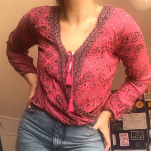 Rosa knytblus - Rosa mönstrad blus med knytdetalj. Storlek XS men passar större.