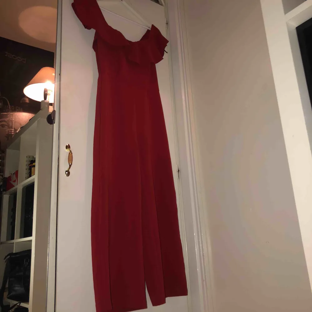 Röd jumpsuit från H&M i storlek 38, aldrig använd. Övrigt.