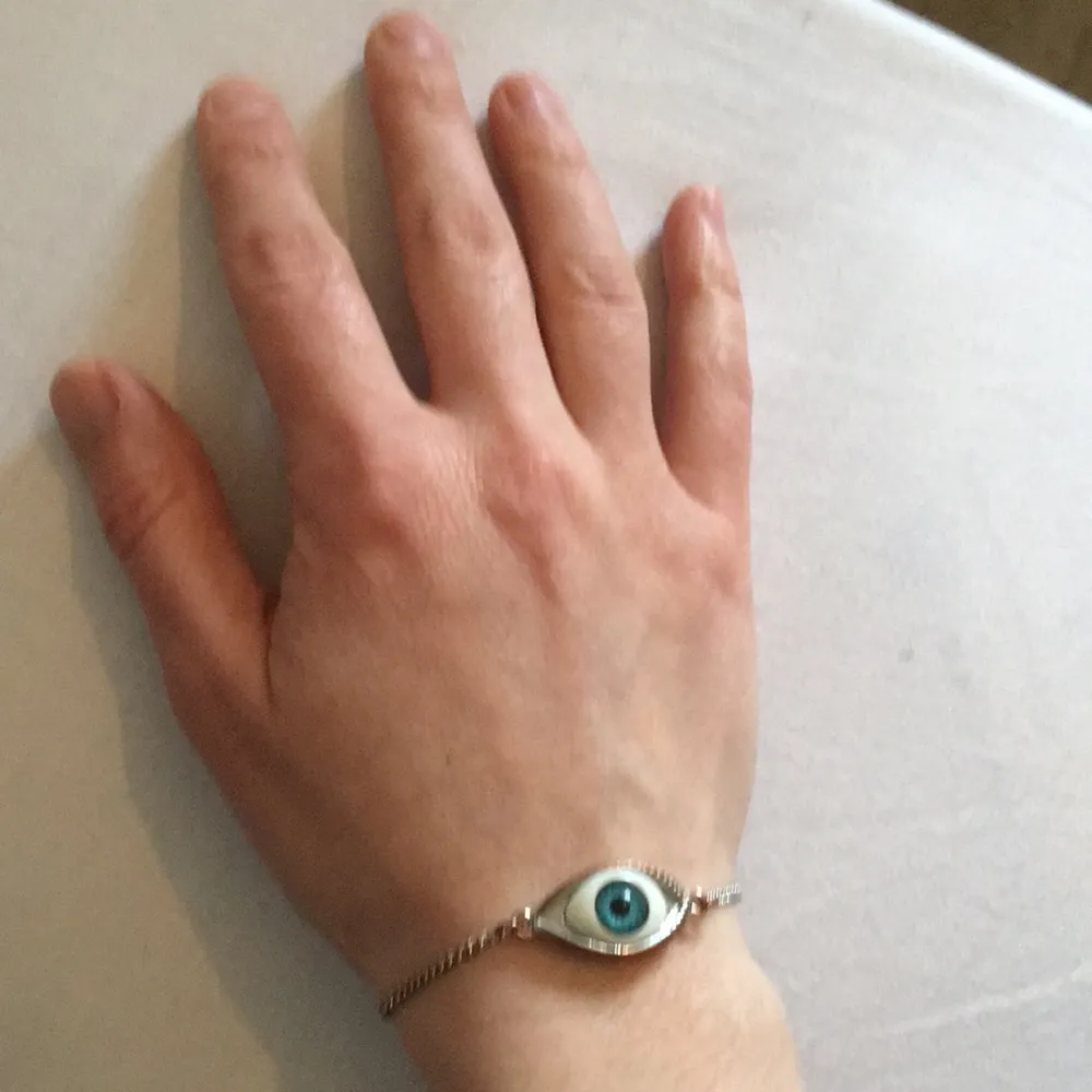 Armband, öga. Ej äkta silver, har blivit kopparfärgad. (Se bild 3) Längd 18 cm utsträckt. (Se bild 1). Accessoarer.