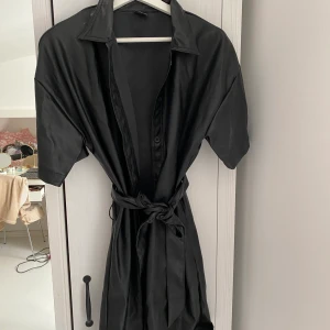 Skinnklänning - Använd 2 ggr. Faux, knytning i midjan. Strl 40 men jag är normalt en 38