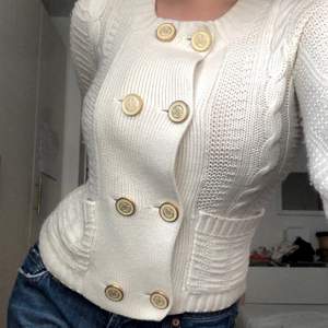 a SUPER CUTE knitted cardigan from Juicy Couture with the most adorable buttons. it has the vintage classy style!  the first picture: the cardigan is a size small on a size medium model.