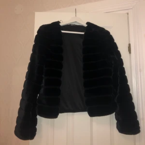 Svart Pälsjacka  - Svart pälsjacka från GinaTricot. Kan knäppas över bröstet med ett knäppe. Använd fåtal gånger💕