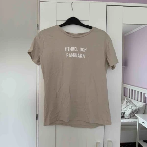  - Beige t-shirt från Lager 157 med tryck ”HIMMEL OCH PANNKAKA” på framsidan. Felfri Kan hämtas i Kalmar annars står köparen för frakten 