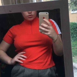  - Orange kortärmad polo zipper med vita detaljer på armarna 