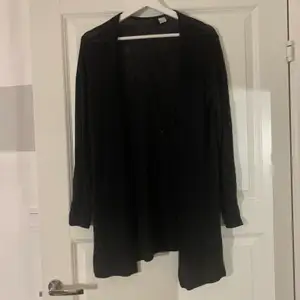 En svart kofta ifrån H&M, den är endast använd en gång. Den går ner till höfterna och är öppen. Fin att ha till ett linne eller en t-shirt.