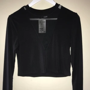 Svart croptop storlek M - Svart långärmad croptop med mesh på bröstet, aldrig använd och lappen kvar. Den är för stor för mig
