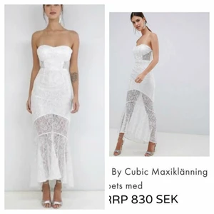  - Snygg och sexig klänning från C by Cubic. Bilderna gör den inte rättvisa. Klänningen är den ultimata festklänningen och har en stretchig och figurnära passform . Eterisk, luftig och lätt.  Bandeau design i tunn spets med detaljer i silver.Maxilängd. Vadderade kupor. Förstärkt med skenor i sidorna. Dragkedja dold bak. Skir Fishtail modell. Underkjol. Strlk UK10/EU38 Regular fit-normal i storleken.Material: Body: 50% polyamid, 30% viskos, 20% lurex metallic-fibrer, foder: 100% polyester. Nypris 830 kr Säljs 350 kr +48 kr Frakt tillkommer. Priset kan diskuteras vid en snabb affär.Avhämtning i Södertälje centrum/Skickar mot frakt. Swish. 10% utav såld vara ges till välgörenhet genom targetaid.com skickar screenshot med donationen. Titta gärna på mina andra annonser.      