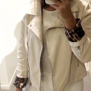Skinnjacka i ljus beige  - Säljare denna ursköna ljust beiga skinnjacka med leopardmönstrat tyg på insidan för att göra plats i garderoben, lagom passform för storlek 38