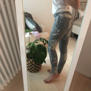  - Byxor med spacemönster bak och fram! Gråa jeans, i stretchigt material. Precis lagom längd på mig som är ca 170 cm lång. W: 25. L: 30. 
