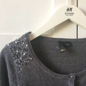  - Kort kofta med paljetter över axlarna. Aldrig använd. Djur finns i hemmet. 