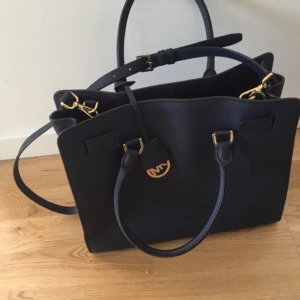  - Blue leather handbag. 