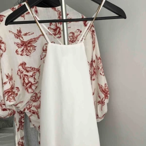  - Somrig blus från BIK BOK i storlek S. Axelremmarna har guldiga detaljer och korsar i ryggen. 
