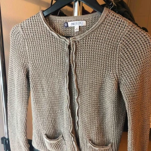  - Jennifer Lopez Cardigan Used once with good condition Size: medium Color: light brownish grey w/ silver 