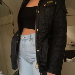 Barbour jacka svart storlek 38/M - Jättefin jacka från barbour! Den har 5 fickor och ett bälte i midjan och guld detaljer! Nypris 2000kr pris kan diskuteras