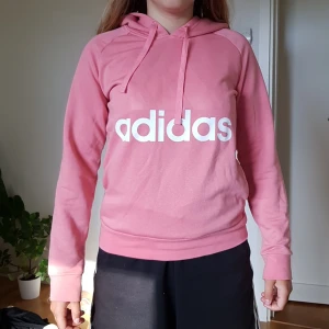 Rosa Adidas Hoodie - Rosa adidas hoodie, frakt ingår i priset. Betalar via swish. Är i nyskick då den knappt är använd. Skriv om du har frågor eller vill ha mer bilder.